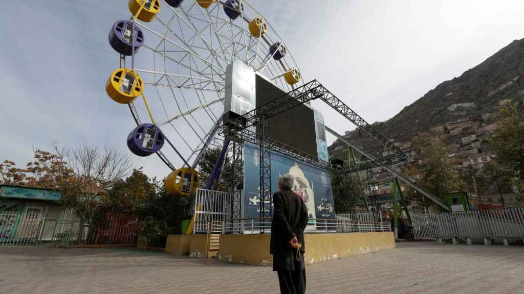 A man, in an amusement park in Kabul.