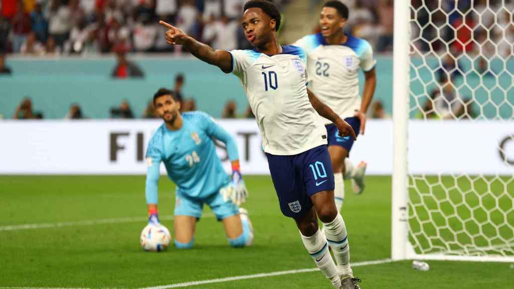 Raheem Sterling celebrates his goal against Iran, England's third