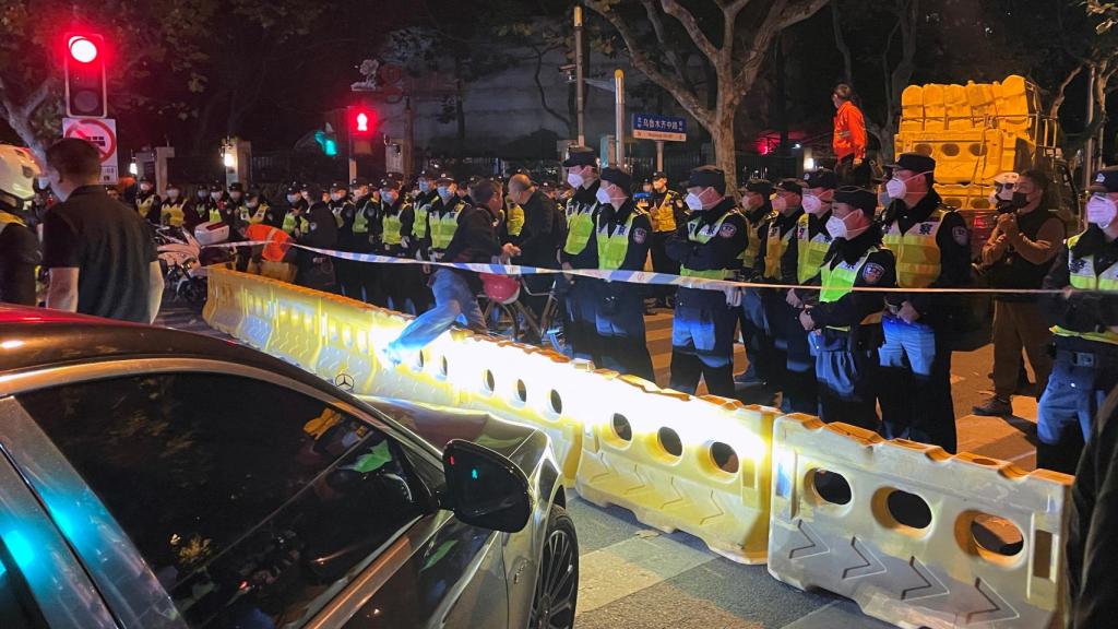 Police officers behind barricades and cordons in Shanghai