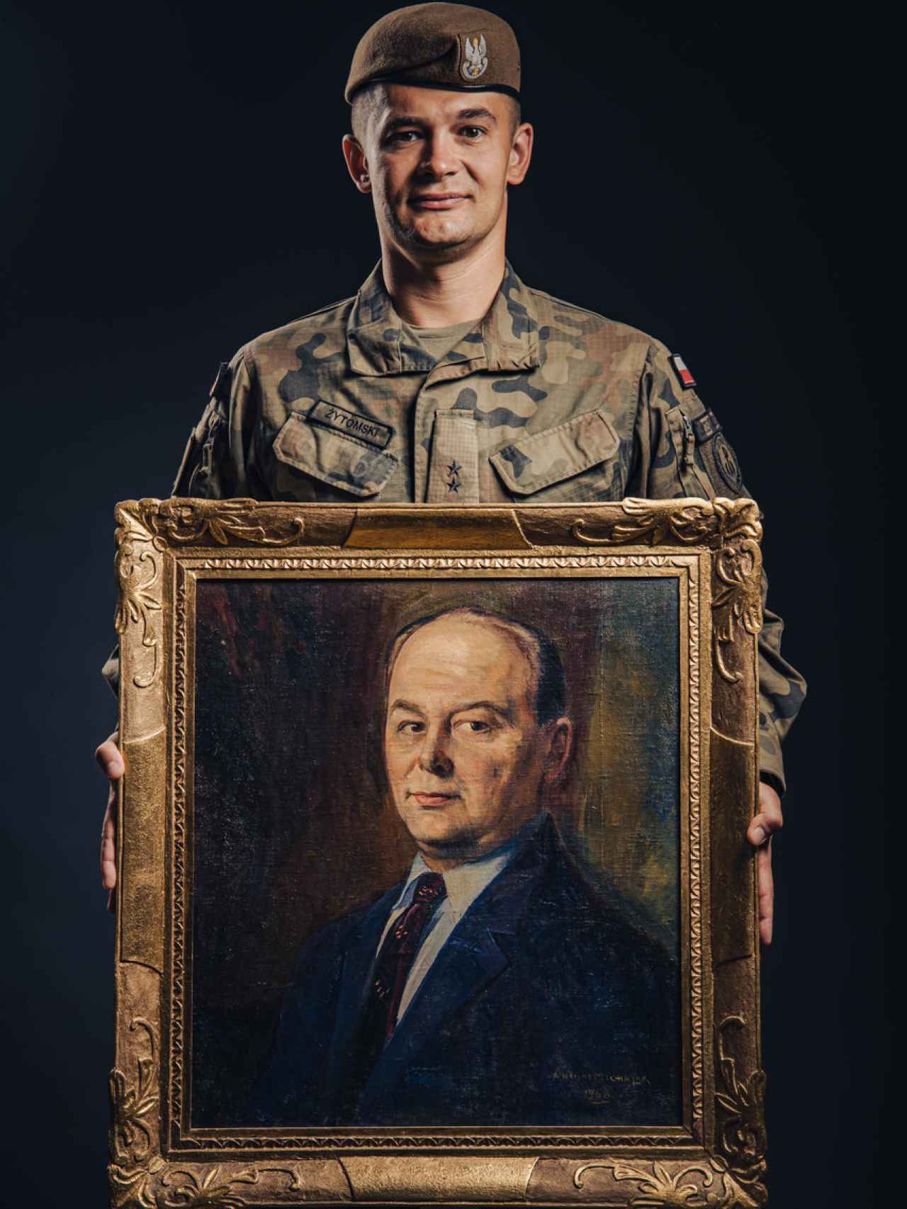 El teniente Marcin Zytomski posa con el retrato de su abuelo.