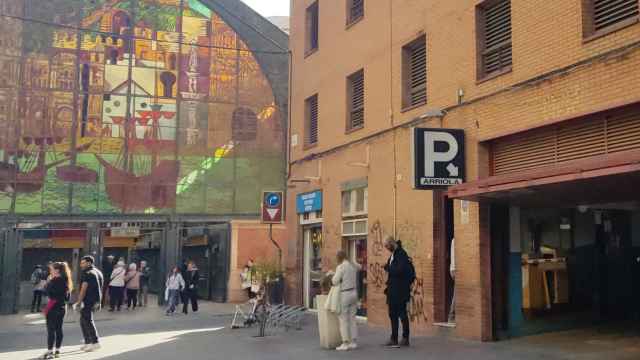 Imagen de la entrada del aparcamiento subastado por el Gobierno central y, al lado, el Mercado de Atarazanas de Málaga.