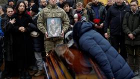 Una madre besa el ataúd con los restos de su hijo, un soldado ucraniano, en Bakhmut.