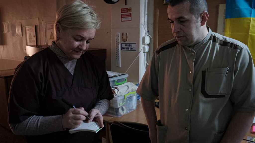 Surgeons Tatiana Kabachok and Evgeny Voloshyn, minutes after delivering Oksana.