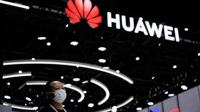 Un persona delante del stand con el logo del Huawei en la feria World Artificial Intelligence Conference celebrada en septiembre de 2022 en Shanghai (China)