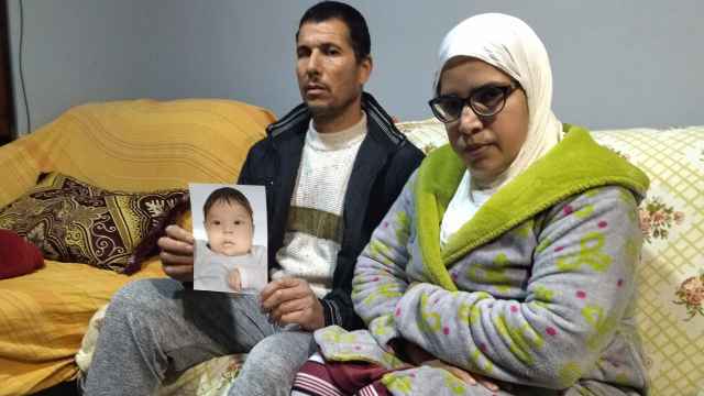 Ahmed junto a su esposa, Khadija, este lunes, en su casa de Alcantarilla, mostrando una foto de su difunta bebé Safaa a la que han tenido que enterrar en el cementerio municipal de Murcia.