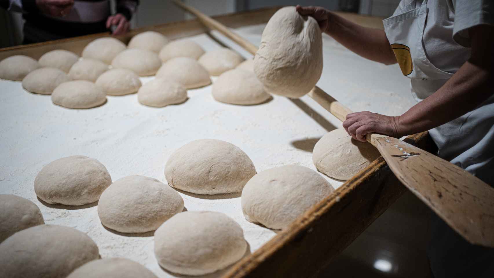 La panadera Rosa María Villarino, manipulando una de las piezas del pan de Cea antes de ser horneado.