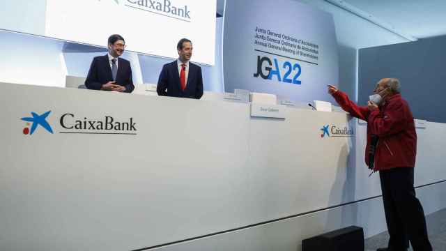 El presidente de CaixaBank, Jose Ignacio Goirigolzarri, y el consejero delegado Gonzalo Gortázar, hablan con un accionista en la Junta celebrada el 8 de abril de 2022, en Valencia.