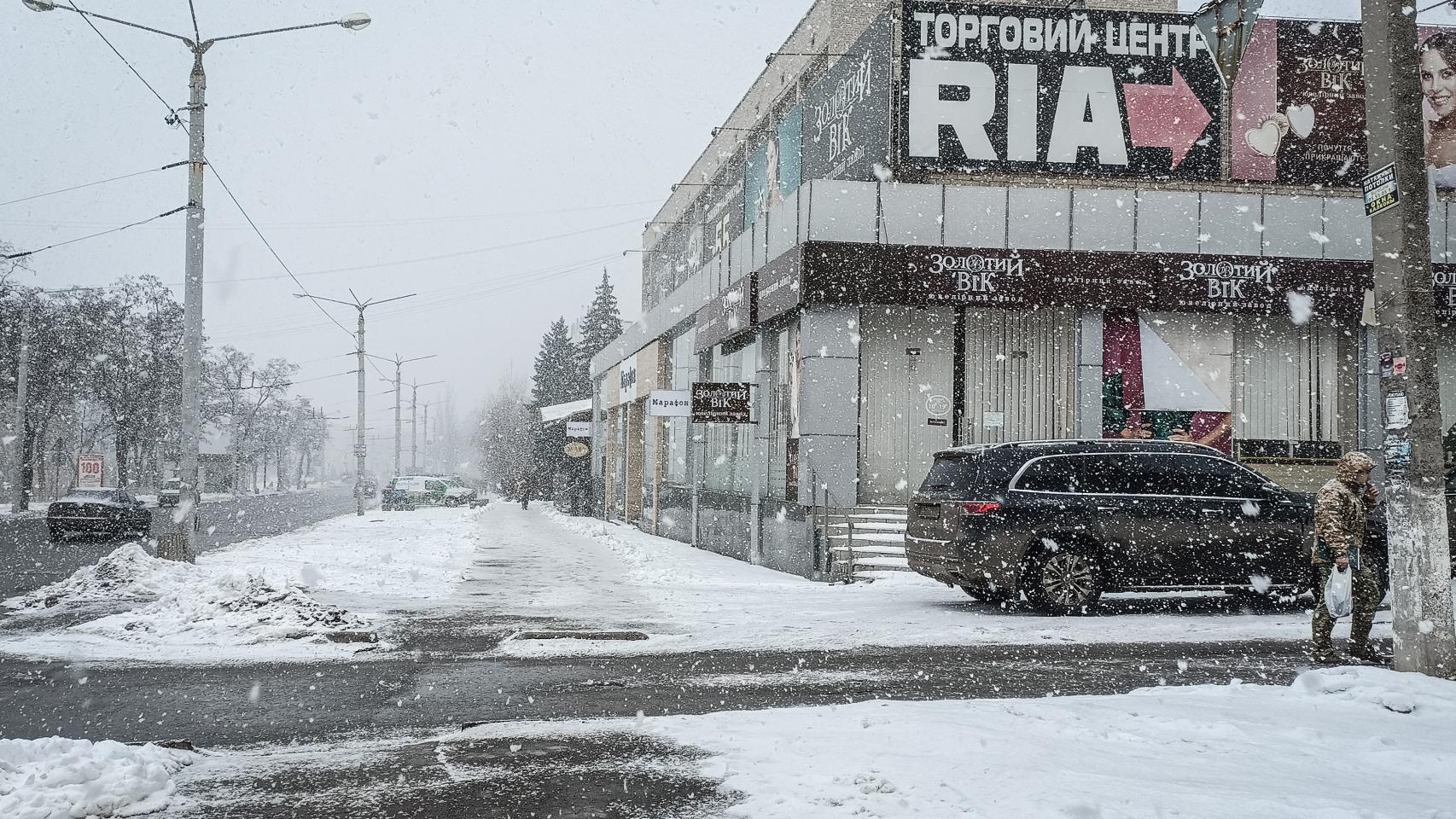 Some soldiers buy food on the main avenue of Kramatorsk, almost deserted these days