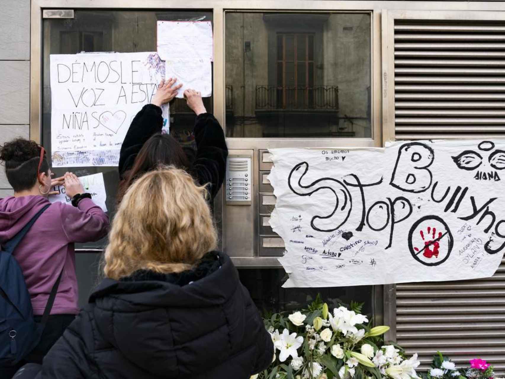 Velas, flores y pancartas en el portal de la víctima en Sallent, Barcelona.