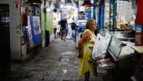 Una mujer pregunta al dependiente qué productos tiene en un mercado de Buenos Aires.