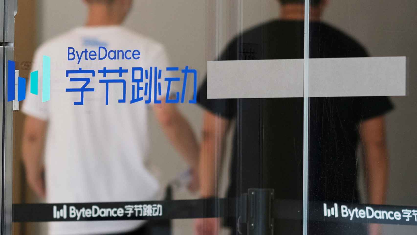 Dos personas detrás del logo de Bytedance, empresa propietaria de TikTok, en su sede en Pekín.