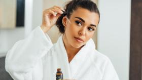 Una mujer aplicando su sérum.
