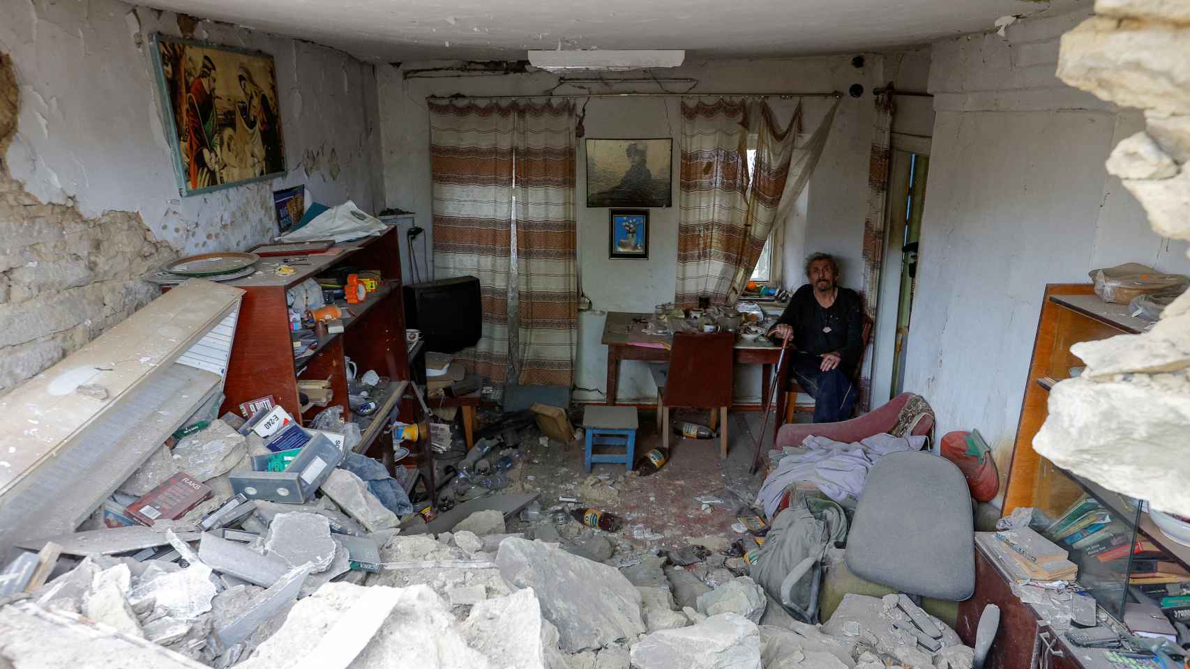 A man in his house, destroyed after a Russian bombing, in Donetsk.