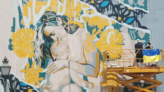 Mikhail Korobkov y Olga Korobkova trabajan en el mural, en el Paseo de la Ribera de Córdoba