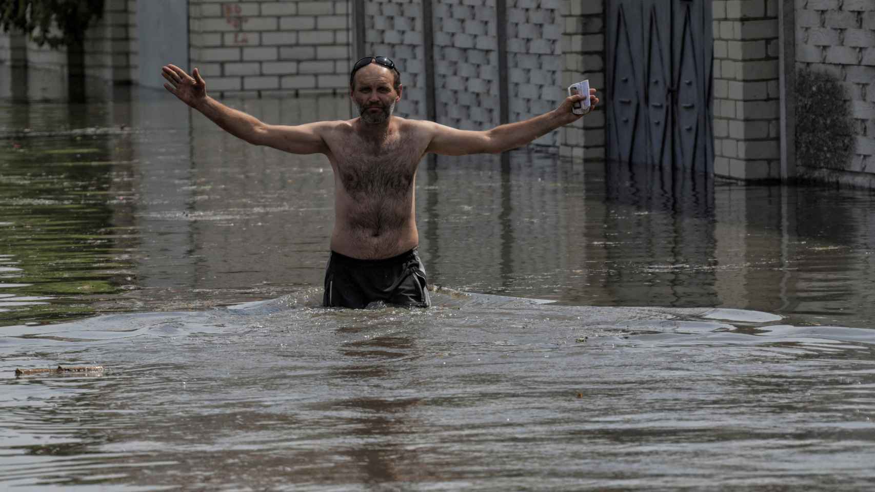 A man walks through the flooded streets of Kherson after the collapse of the Nova Kakhovka dam.