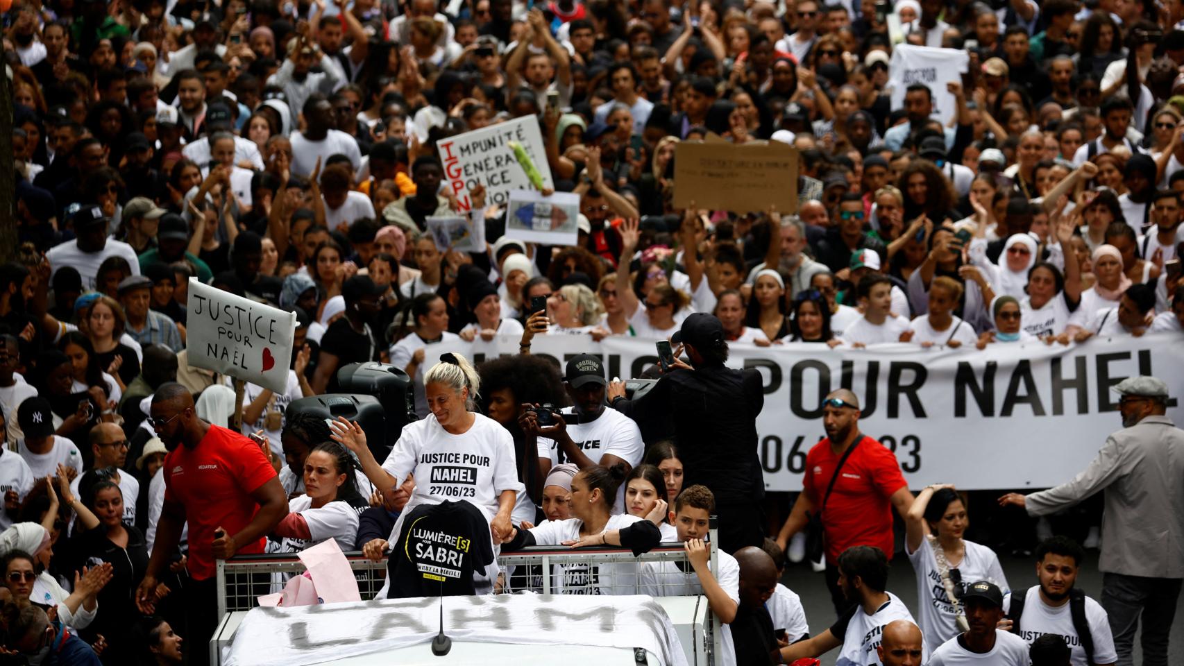 Mounia, Nahel's mother, standing on a van during the 'white march' in tribute to her son.