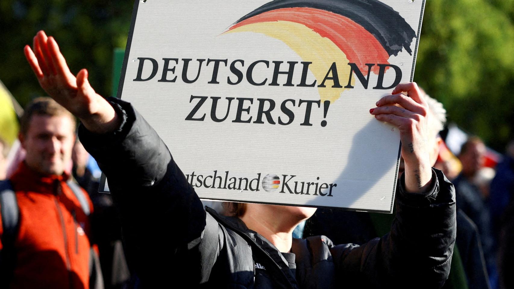 An AfD supporter makes the fascist salute at an anti-government protest on October 8, 2022 in Berlin.