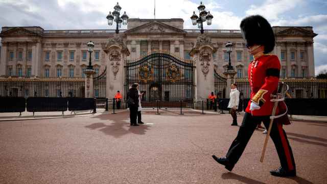 Un miembro de seguridad frente a la fachada de Buckingham Palace